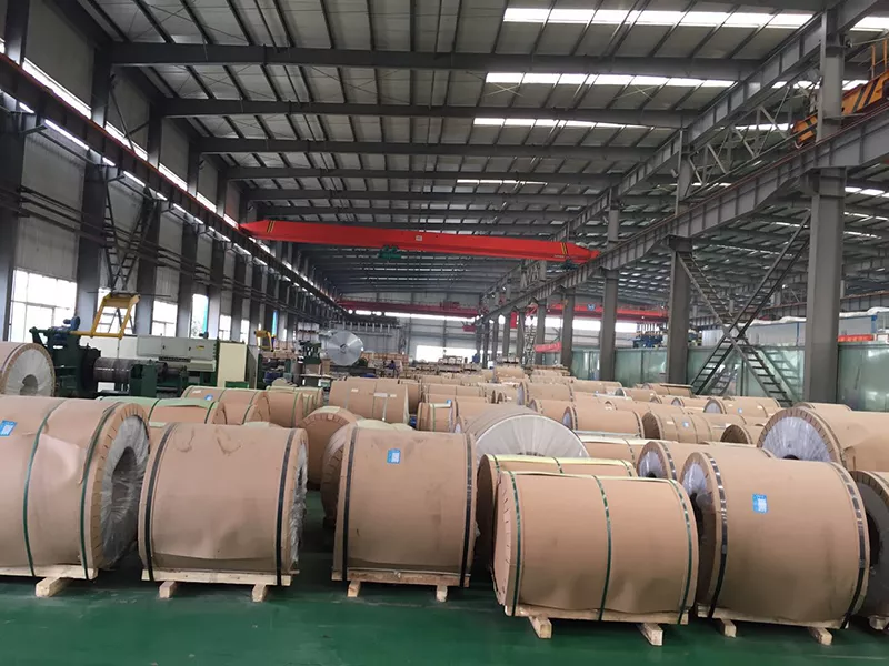 3004 aluminum coil stored in a warehouse with coil identification labels