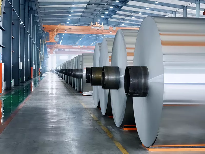 5754 Aluminum Coil finished products neatly stored in industrial workshop with overhead crane