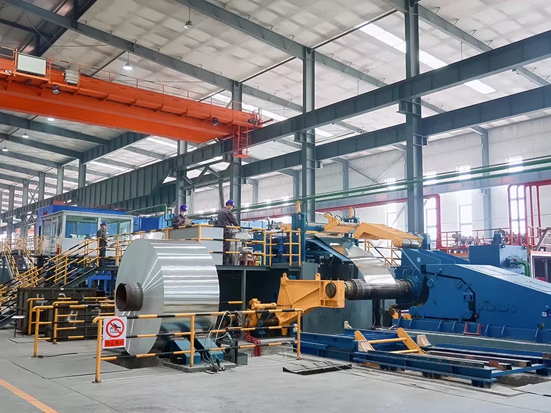 5754 Aluminum Coil being processed on production line with workers operating equipment