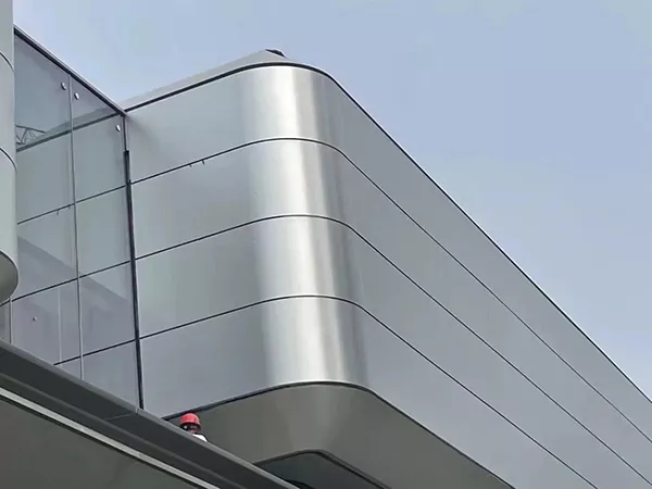 Curved architectural facade panels made from anodized aluminum