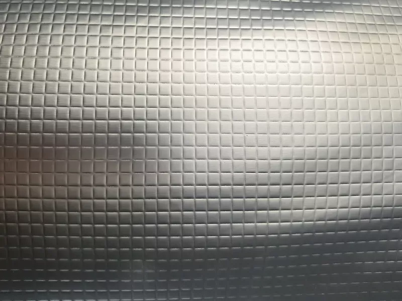 Square grid embossed aluminium foil with a textured surface